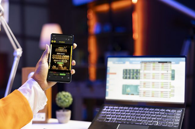 Stockholder working from apartment using mockup mobile phone